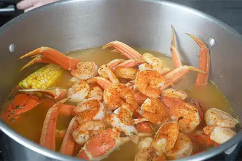 Add crab legs, shrimp, and seasoning