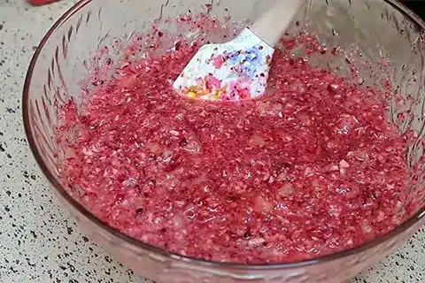 Mixing cranberries, sugar, and pineapple