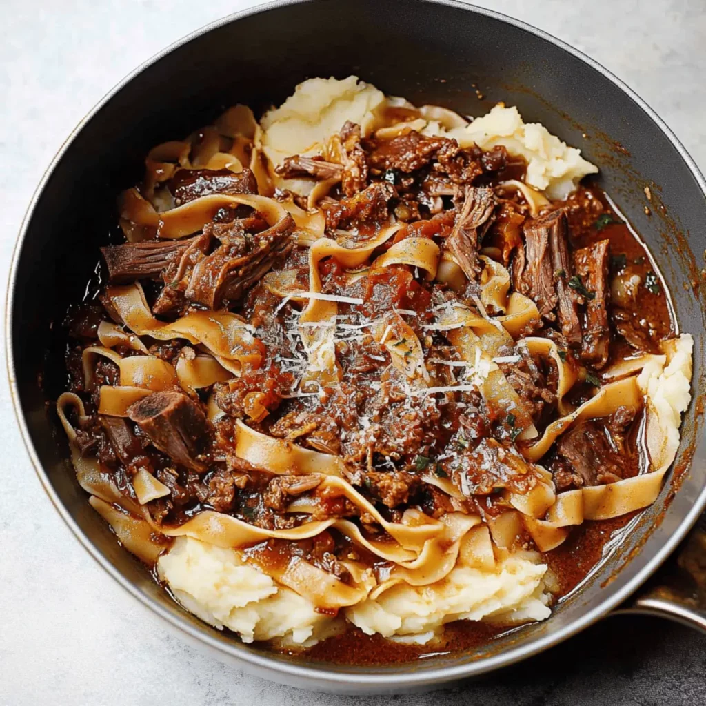 Tender Short Rib Ragu Over Silky Parmesan Mashed Potatoes